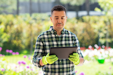 Image showing man with tablet pc at summer garden