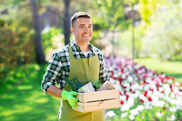 Image showing happy man with tools in box at summer garden