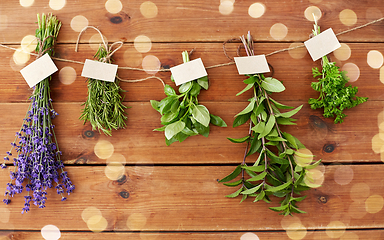 Image showing greens, spices or medicinal herbs on wood