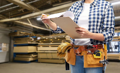 Image showing female worker with clipboard and working tools