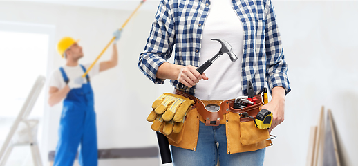 Image showing woman with hammer and working tools on belt