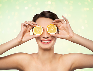 Image showing beautiful woman making eye mask of lemon slices