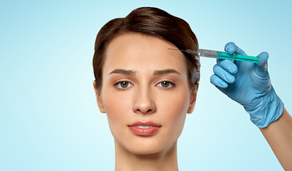 Image showing beautiful young woman and hand with syringe