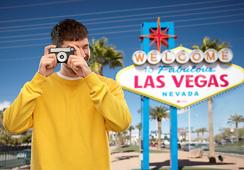 Image showing man with vintage film camera over las vegas sign