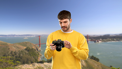 Image showing man with camera over golden gate bridge