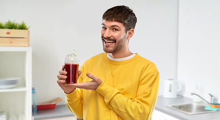 Image showing happy man with tomato juice in takeaway cup