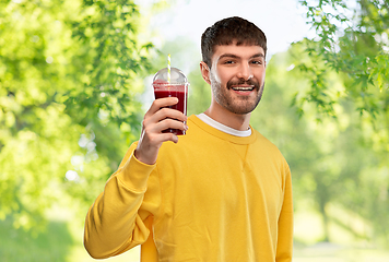 Image showing happy man with tomato juice in takeaway cup