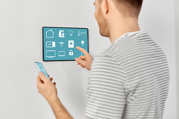 Image showing man with smartphone and tablet pc at smart home