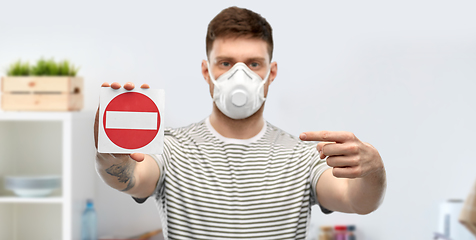 Image showing man in respirator mask showing stop sign