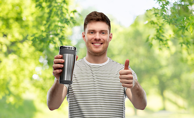 Image showing man with thermo cup or tumbler for hot drinks