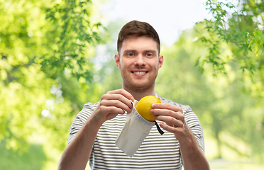 Image showing smiling man with lemon in reusable canvas bag