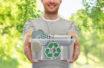 Image showing smiling young man sorting metallic waste