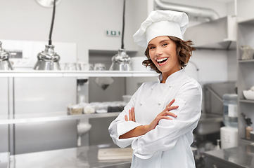 Image showing smiling female chef in toque with crossed arms