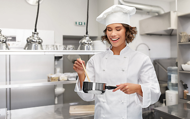 Image showing happy smiling female chef with saucepan