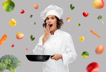 Image showing surprised female chef with frying pan over food