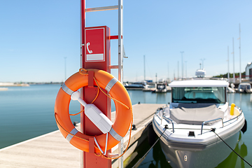 Image showing life ring or lifebuoy hanging on post at sea berth