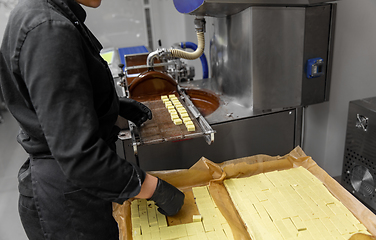 Image showing worker processing candies at confectionery shop