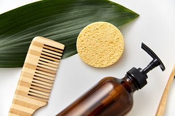 Image showing comb, sponge, liquid soap or shower gel and leaf