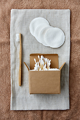 Image showing wooden toothbrush, cotton pads and swabs in box