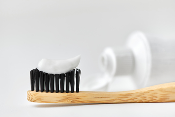 Image showing natural wooden toothbrush with toothpaste on it