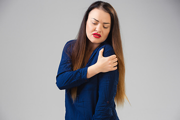 Image showing Young woman suffers from pain, feels sick, ill and weakness isolted on studio background