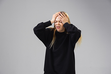 Image showing Young woman suffers from pain, feels sick, ill and weakness isolted on studio background