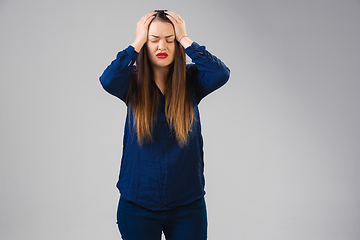 Image showing Young woman suffers from pain, feels sick, ill and weakness isolted on studio background