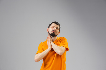 Image showing Young man suffers from pain, feels sick, ill and weakness isolted on studio background