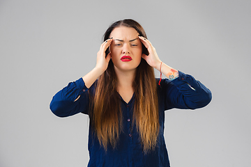 Image showing Young woman suffers from pain, feels sick, ill and weakness isolted on studio background