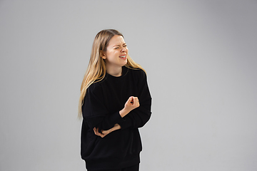 Image showing Young woman suffers from pain, feels sick, ill and weakness isolted on studio background