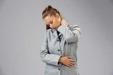 Image showing Young woman suffers from pain, feels sick, ill and weakness isolted on studio background