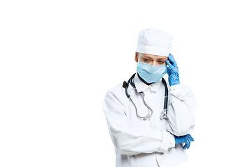 Image showing Female young doctor with stethoscope and face mask isolated on white studio background