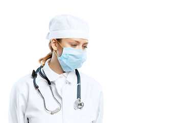 Image showing Female young doctor with stethoscope and face mask isolated on white studio background