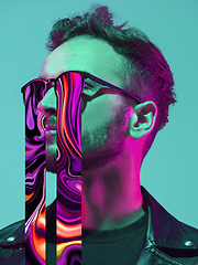 Image showing Modern man\'s portrait on studio background in bright neon light, stylish creative design