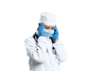 Image showing Female young doctor with stethoscope and face mask isolated on white studio background