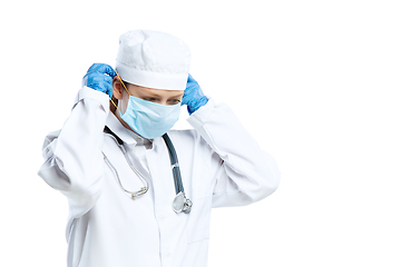 Image showing Female young doctor with stethoscope and face mask isolated on white studio background