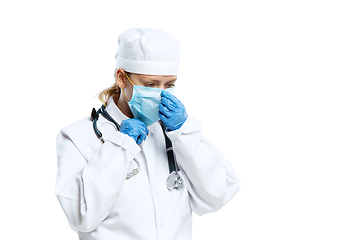 Image showing Female young doctor with stethoscope and face mask isolated on white studio background