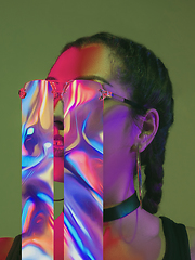 Image showing Modern woman\'s portrait on studio background in bright neon light, stylish creative design