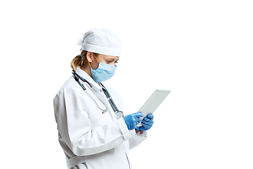 Image showing Female young doctor with stethoscope and face mask isolated on white studio background