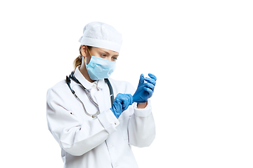 Image showing Female young doctor with stethoscope and face mask isolated on white studio background