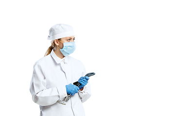 Image showing Female young doctor with stethoscope and face mask isolated on white studio background