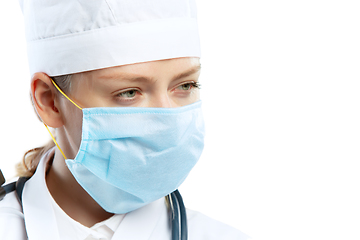 Image showing Female young doctor with stethoscope and face mask isolated on white studio background