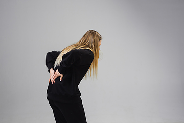 Image showing Young woman suffers from pain, feels sick, ill and weakness isolted on studio background