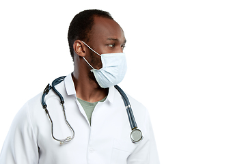 Image showing Male young doctor with stethoscope and face mask isolated on white studio background