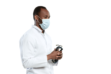 Image showing Male young doctor with stethoscope and face mask isolated on white studio background