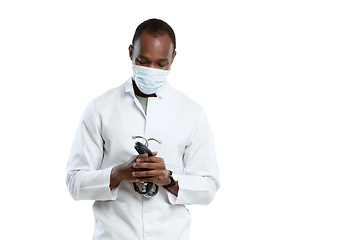Image showing Male young doctor with stethoscope and face mask isolated on white studio background