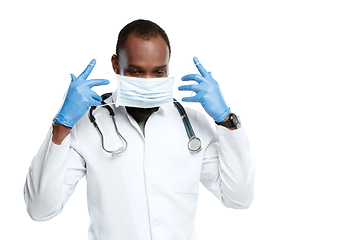 Image showing Male young doctor with stethoscope and face mask isolated on white studio background