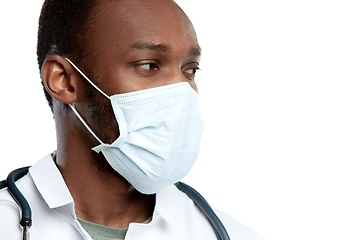 Image showing Close up young doctor with stethoscope and face mask isolated on white studio background