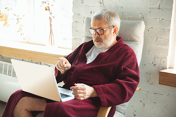 Image showing Mature senior older man during quarantine, realizing how important stay at home during virus outbreak