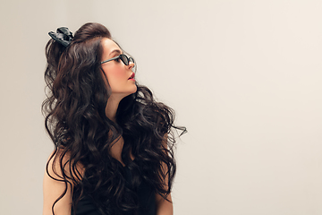 Image showing Portrait of beautiful young woman isolated on grey studio background